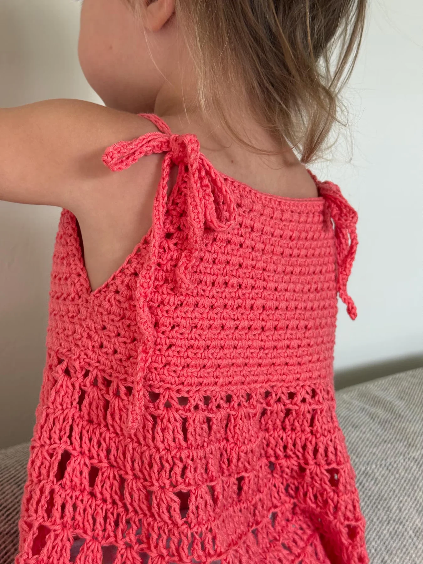 Coral Solara kids' tank with bow-tie straps and a decorative hem